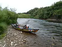 kayak on rocky beach next to river