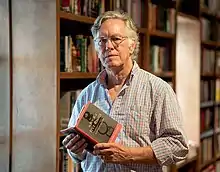 Wilson at Books and Books in Coral Gables, holding a copy of The Book of Five Rings