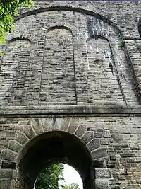 Large blind arch containing three smaller blind arches