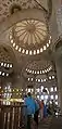 Interior of Sultan Ahmed Mosque ("Blue Mosque"), Istanbul. The main dome is surrounded by four semi-domes, three of which are visible in this image. They in turn have smaller semi-domes hanging off them.