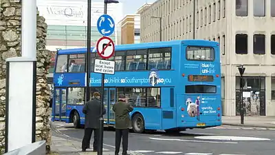 Bus spotters photographing a bus in Southampton, UK