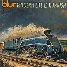 The album cover in a style of a painting shows 4498 "Mallard", an LNER A4 steam locomotive, pulling a passenger train on the railway. A hill can be seen in the background.