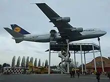 Ventral view of museum aircraft raised on struts.