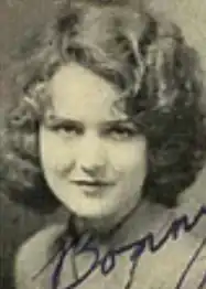 A young white woman with dark curly hair