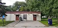 Small one-story wooden building with two doors. The sign reads "United States Post Office, Borup, Minnesota 56519".