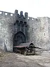 Burnt-out castle gate and battering ram