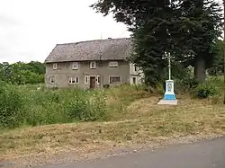 Wayside cross and a house