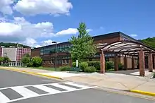 Two-story brick building façade, entranceway, and round theater