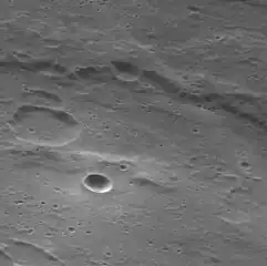 Oblique view of circular bright crater within Manley