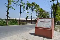 Stone plaque pointing towards Buddha relic distribution site