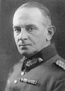 A man with short hair combed back wearing a military uniform.