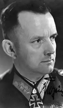 A black-and-white photograph of a man in semi profile wearing a military uniform and a neck order in shape of an Iron Cross.