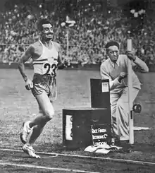 A black and white photo of a track athlete wearing the number 23 running.