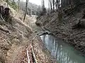 The Canal d'Entreroches passing through Mount Mormont