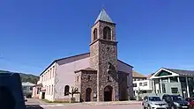 A pink cathedral with a bell tower at the centre