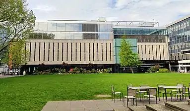 The Central Library, the college's main academic library, overlooks Queen's Lawn. The top two floors were built as part of a modern extension to the library