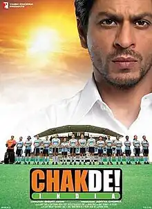 Theatrical release poster depicts coach Kabir Khan, looking over the bad Indian Women's National Field Hockey Team. Text at the bottom of the poster provides the title, tagline, production credits and release date.