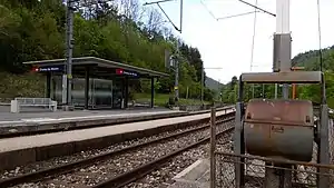 Canopy-covered shelter next to double-track railway line