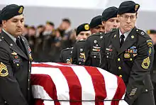 A casket team from the 1st Special Forces Group carries the flag-draped casket of Sergeant First Class Nathan Chapman on January 8, 2002.