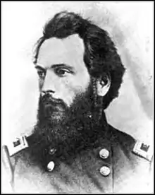 Black and white photo of a bearded man in a dark military uniform with general's stars on the shoulder tabs