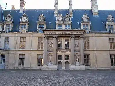 Courtyard entrance to the north wing, attributed to Jean Bullant, a very early use of the Colossal order of columns in Renaissance architecture, with niches for Michelangelo's statues, "The Slaves".