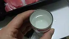 Clear liquid in a small cup