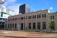 Photo of large building covered in coloured dots.