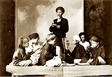 A private class at a home in Vietnam (1895). The students studying are sitting on a sập.