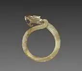 Fluted ring with a dragon head (huan); circa 475 BC; jade (nephrite); overall: 9.1 centimetres (3.6 in); Cleveland Museum of Art (Cleveland)