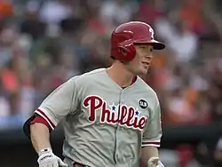 A baseball player in a gray jersey