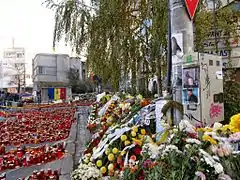 Candles and wreaths at the site of Club Colectiv