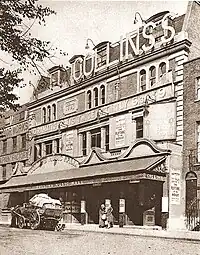 exterior of theatre with horse and cart stationary in front of it