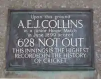 A plaque that reads: "Upon this ground // A. E. J. COLLINS // in a junior House Match // in June 1899 scored // 628 NOT OUT // THIS INNINGS IS THE HIGHEST // RECORDED IN THE HISTORY // OF CRICKET"