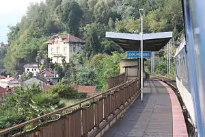 Looking out from a train window at a single side platform