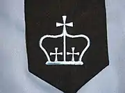 The crown embroidered on the university's academic regalia