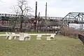 Reading circle, with Westchester Avenue station ruin and a New York City Subway train on 6 train service in the background