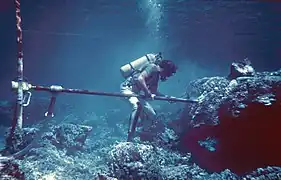 Coral drilling to recover a core for studying paleoclimate change.