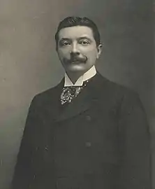 antique photo of a formally dressed dark haired man