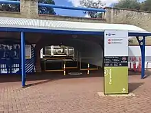 Entrance to underpass with shelter and signage out front