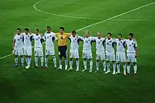 The team standing together before a match.