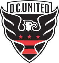 A shield with stylized black eagle facing right with three red stars and two red strips across its chest, and the words "D.C. UNITED" above.