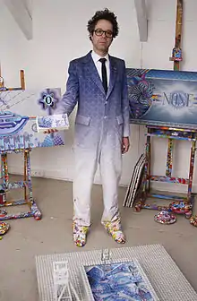 Dadara in his studio with works from the Exchanghibition Bank project, 2011.