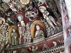 Cave 12. Phase II, after 465 AD. Yungang Grottoes, Datong: musicians playing the pipa and sheng overlook the passing scene.