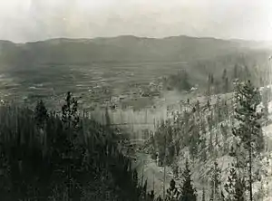 An aerial view of construction of the dam and the empty lake basin