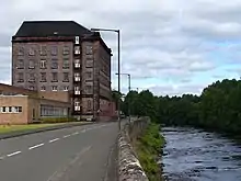 Former mill buildings by the River Teith, now Deanston Distillery