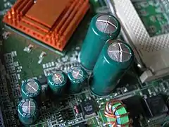 Swollen electrolytic capacitors – the special design of the capacitor tops allows them to vent instead of bursting violently.