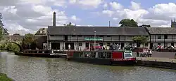 Water with two narrow boats and bridge