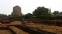 As it appeared in 2019. Camera angle from the ruins of the ancient Mulagandha Kuti Vihar towards the Dhamek Stupa; the Shreyanshnath Jain Temple can be seen on the right side of the photograph (the Panchayatan Temple can also be seen in the middle).