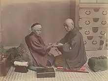 Image 23A doctor checks a patient's pulse in Meiji-era Japan. (from History of medicine)