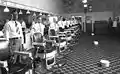 Staff of Draper's Barber Shop, Franklin Street, Martinsville, 1920. White bowls on floor are spittoons